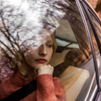A woman looking out a car window