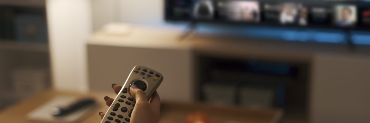 11 Comfort Characters That Helped People Through Trauma Young woman relaxing on the couch at home and watching videos on demand on her TV, entertainment concept