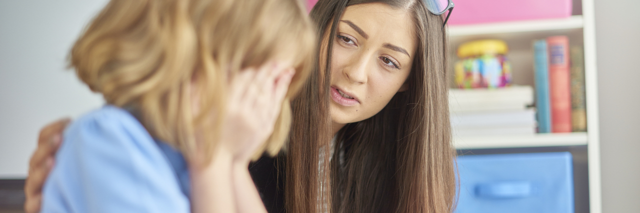 10 Careers That Could Benefit From Trauma-Informed Care Training photo of young woman offering support in school to upset girl