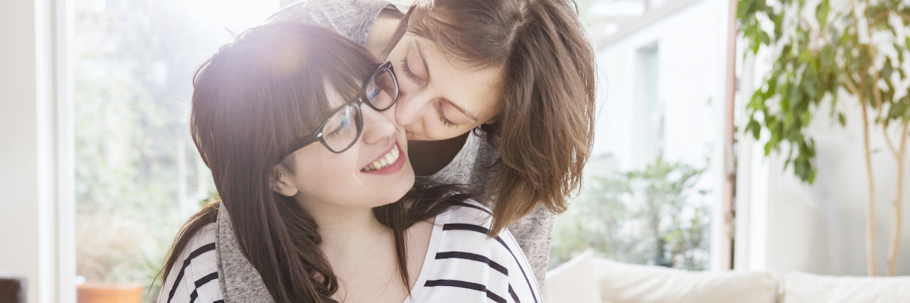 Compliments for Your Partner in Eating Disorder Recovery Woman kisses girlfriend on the cheek at breakfast