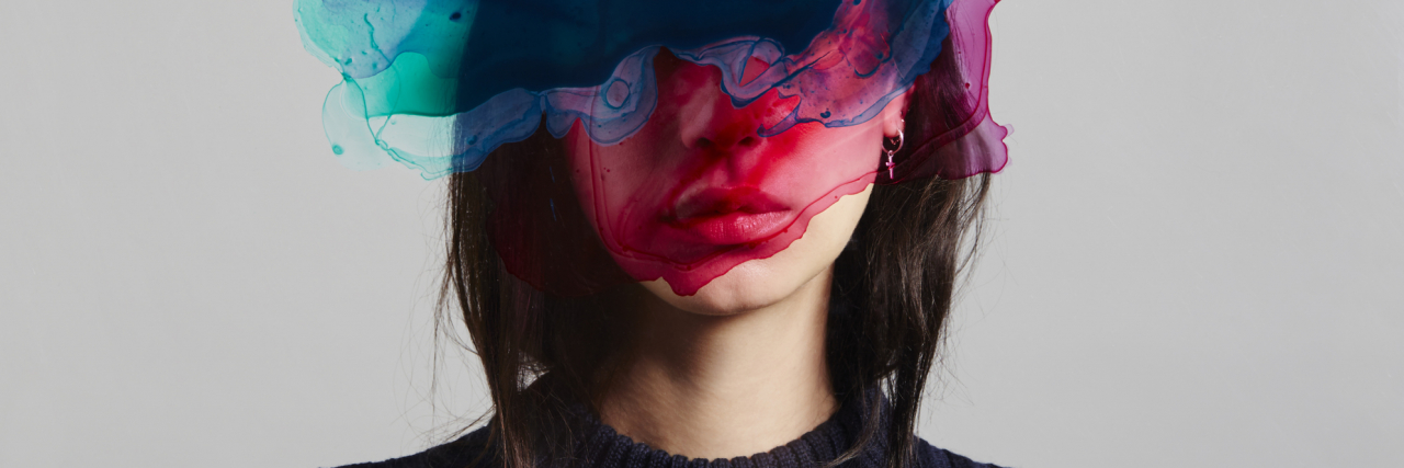 How I've Masked My Borderline Personality Disorder Symptoms photo of a woman with face hidden by ink