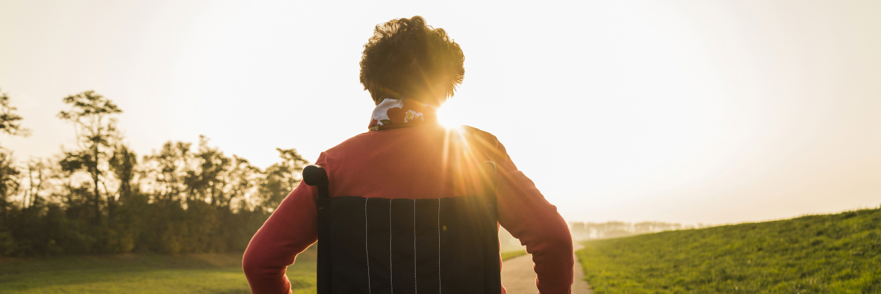 How to Cope With Cerebral Palsy and Functional Decline Woman in wheelchair on trail at sunset.