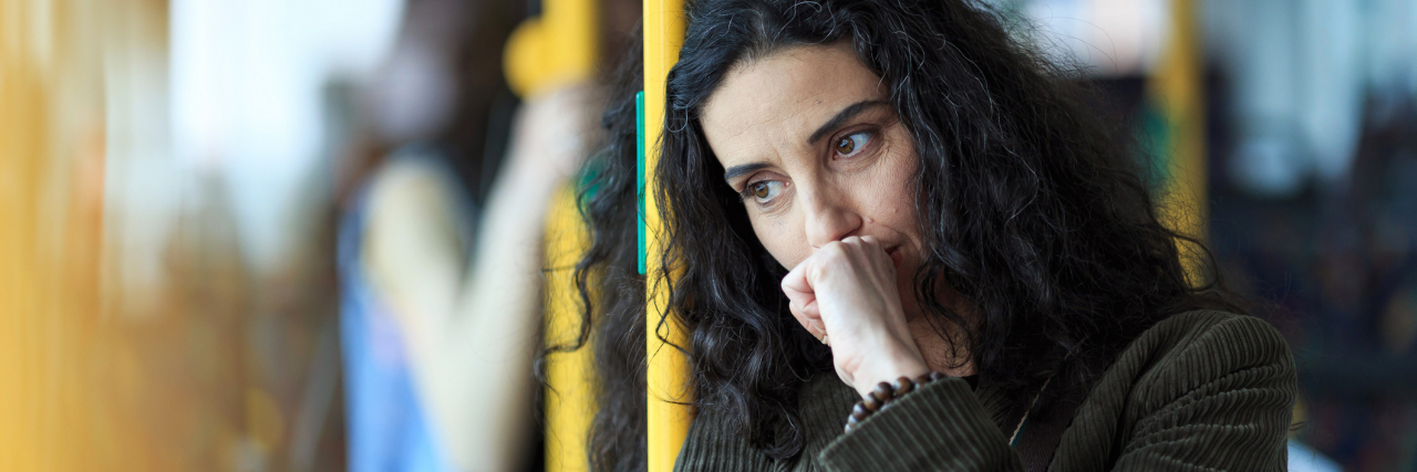 Advice For Someone Newly Diagnosed With Bipolar Disorder photo of a young woman looking upset or thoughtful on a bus