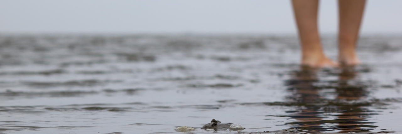 This Is What Chronic Fatigue Syndrome Actually Feels Like Woman wading through mud.