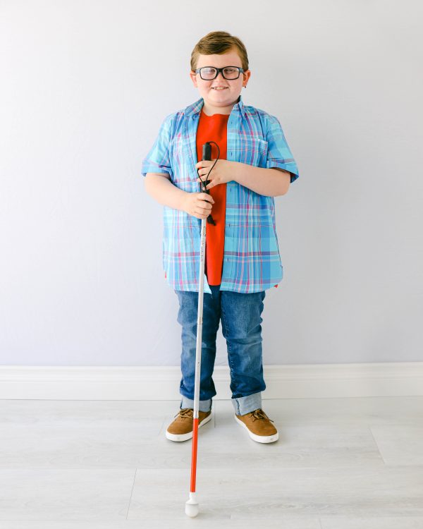 Karl's headshot showing him wearing glasses and holding his cane, in front of a white background (photo by Gayle Dawn photography) 