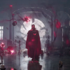 A screencap of Doctor Strange in The Multiverse of Madness where he's surrounded by red magic, candles, and a book