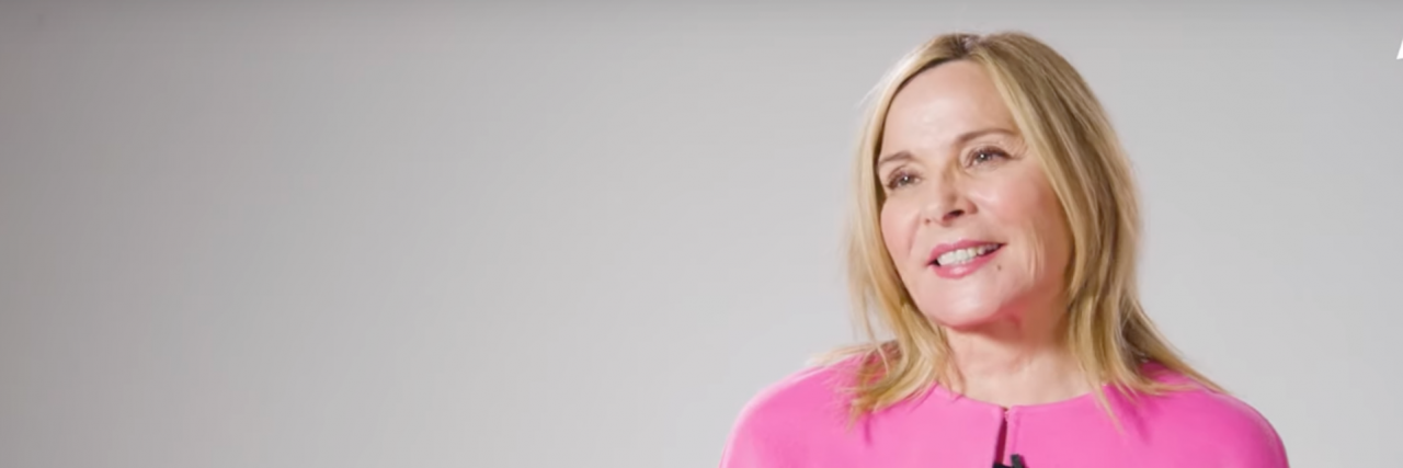 What ADHD Folk Can Learn From Kim Cattrall's Vanity Cover Shoot Kim Cattrall in bright pink sitting against a white background