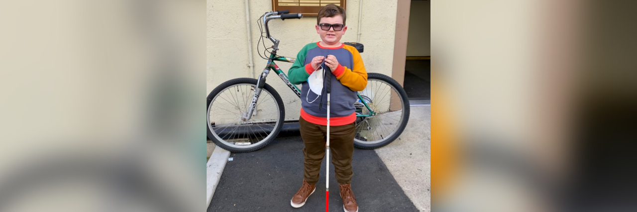 Visually Impaired Actor and 2nd Grader Karl Seitz From 'This Is Us' Karl Seitz in front of the sound stage on the set of "This Is Us". He is holding his cane and also standing in front of a bicycle.