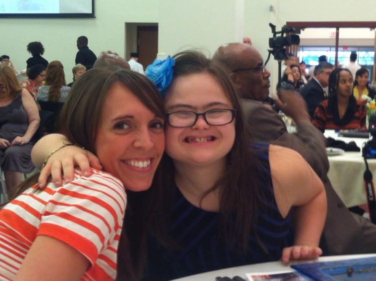 Rachel with her teacher at an awards ceremony.