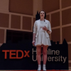 Contributor standing on TEDx stage