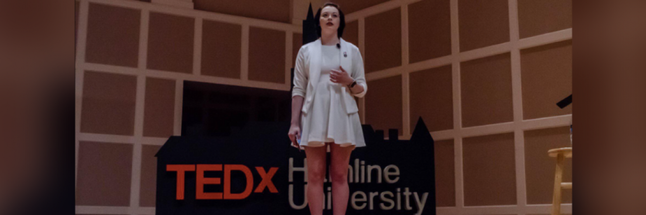 Why I Couldn't Talk About My Sexual Assault When I Was Younger Contributor standing on TEDx stage