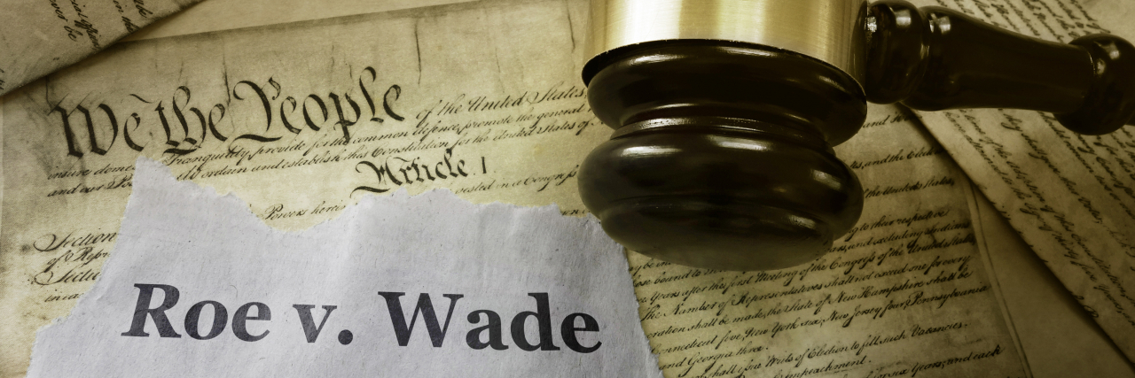 9 People With Health Conditions the Justices Who Overturned Roe v. Wade Didn't Stop to Consider Roe v Wade news headline with gavel on a copy of the United States Constitution.