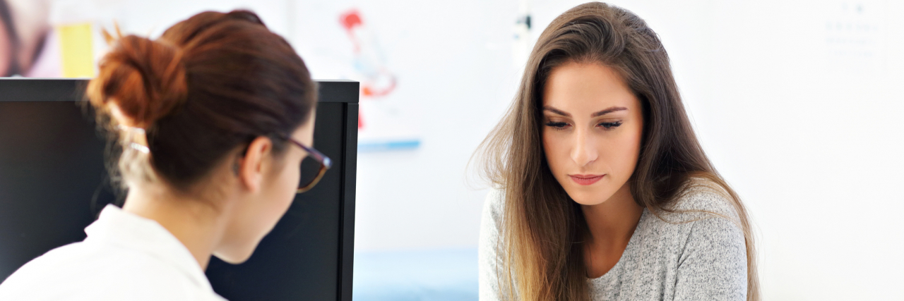 To the Doctor Who Showed Compassion During My Mental Health Crisis photo of a woman speaking with a female doctor at medical office
