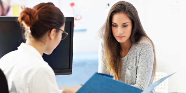 photo of a woman speaking with a female doctor