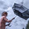Woman fighting rainstorm.