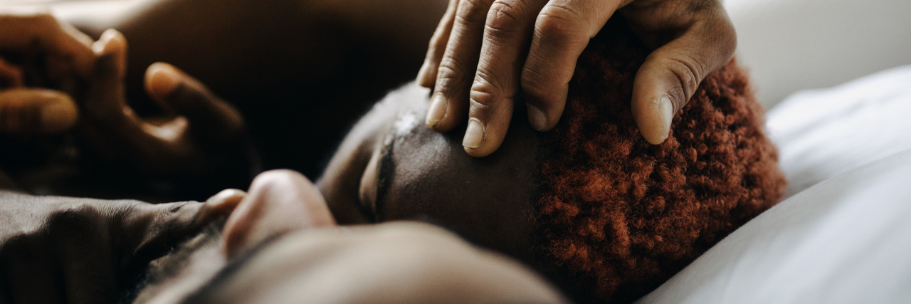 Desirable Mental Health Reflections That You Want Your Partner to Say Two men embracing while laying in bed together after meeting up using a dating app.