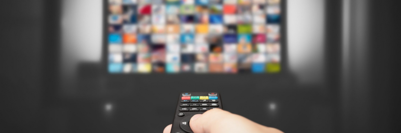 Video on demand, TV streaming, multimedia. Hand holding remote control