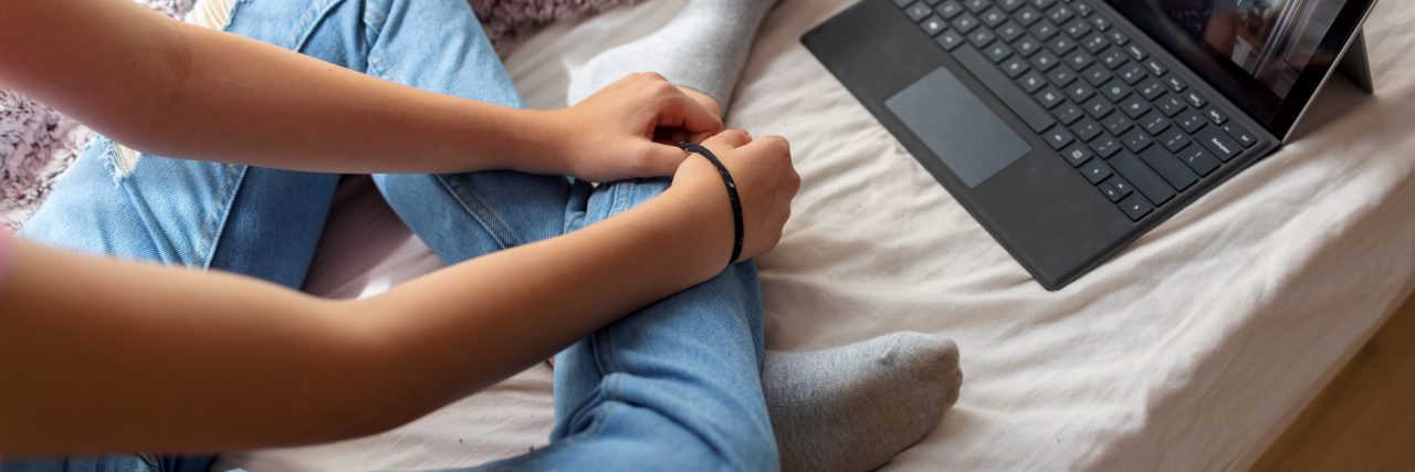 How to Tell Your Therapist You Got Back With Your Toxic Ex girl has psychotherapy session with her therapist via video call. She has rubber band on her wrist to prevent anxiety.