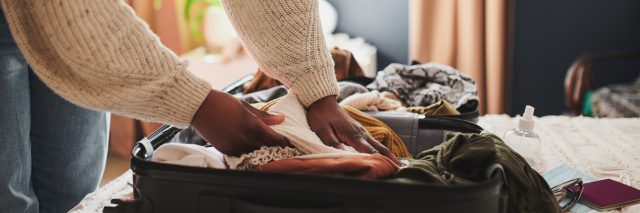 Cropped shot of an unrecognizable woman packing her things into a suitcase at home before traveling