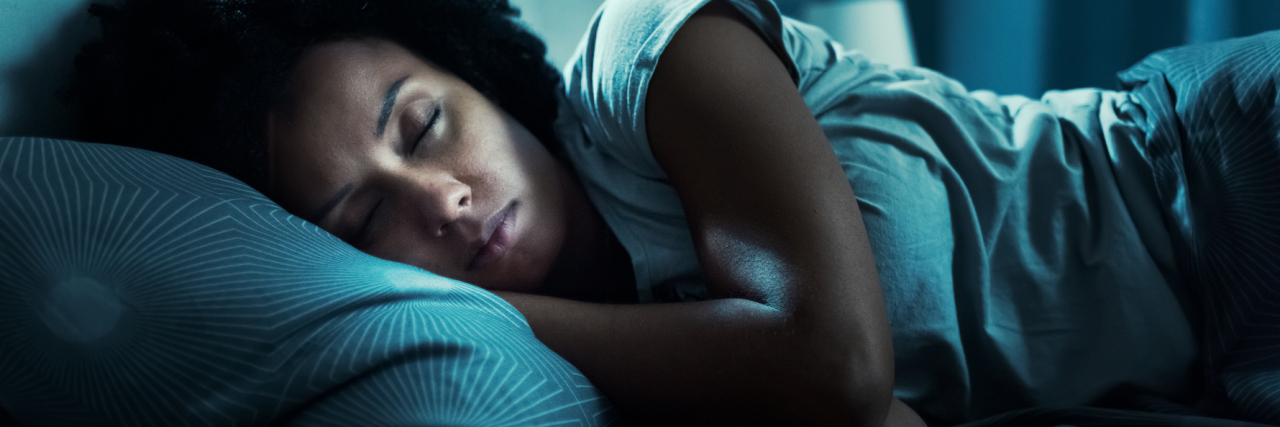 Tips That Really Help People Sleep With Anxiety photo of a woman fast asleep in her bed at night, cant sleep tips concept