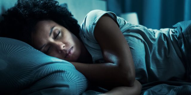 photo of a woman fast asleep in her bed at night, cant sleep tips concept