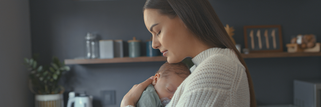 Treatment for Postpartum Depression Saved My Mental Health Woman of color holding her newborn