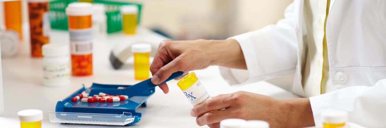 How Pharmacy Benefit Managers Make Medications Expensive and Hard to Access Pharmacist filling prescription