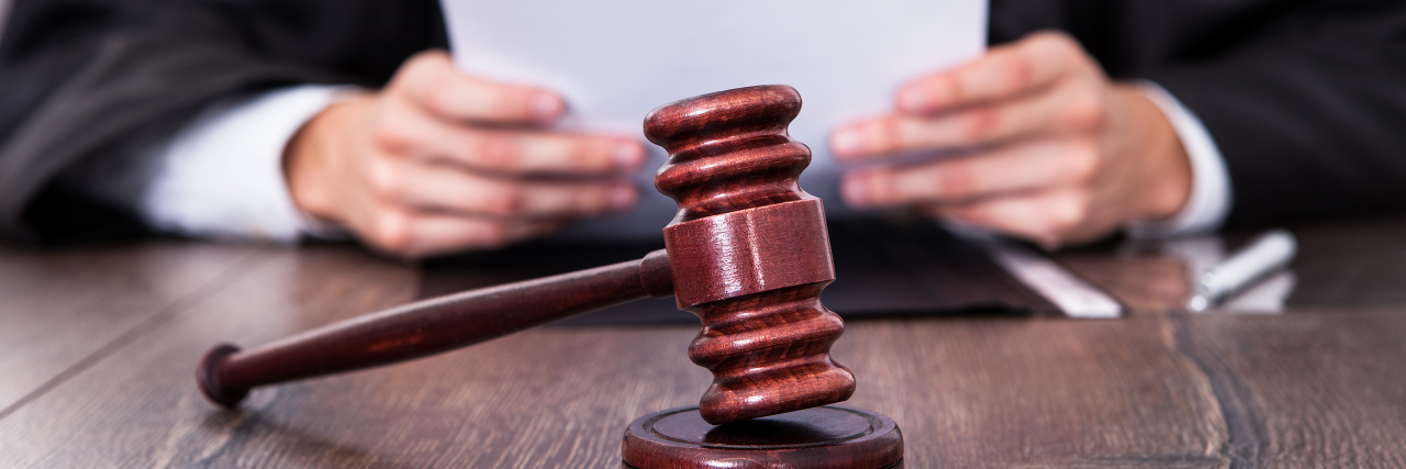 The Amber Heard/Johnny Depp Verdict Is in and the Winner Is… Nobody Close-up Of Male Judge In Front Of Mallet Holding Documents