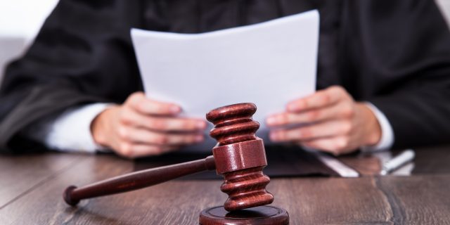 The Amber Heard/Johnny Depp Verdict Is in and the Winner Is… Nobody Close-up Of Male Judge In Front Of Mallet Holding Documents