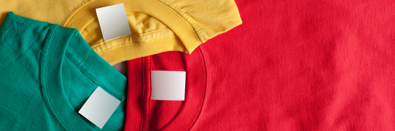 You Don’t Have to Label Trauma or Mental Illness to Heal From It Three colorful t-shirts with blank labels.