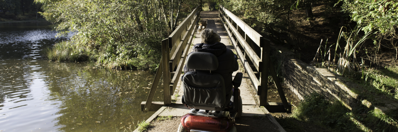 Why I Have a Love/Hate Relationship With My Mobility Devices Woman using mobility scooter outdoors.