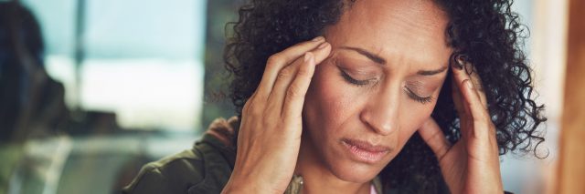 Woman experiencing a headache or migraine.