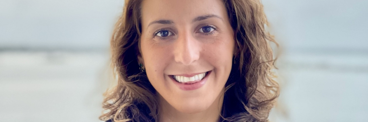 How to Protect LGBTQIA+ Youth Mental Health: A Psychologist's Advice headshot for Dr. Natasha Poulopoulos, pediatric psychologist who specializes in LGBTQIA+ mental health