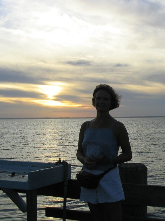 The author stands in front of the ocean.