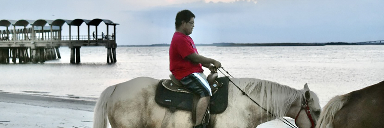 Raymond riding a horse