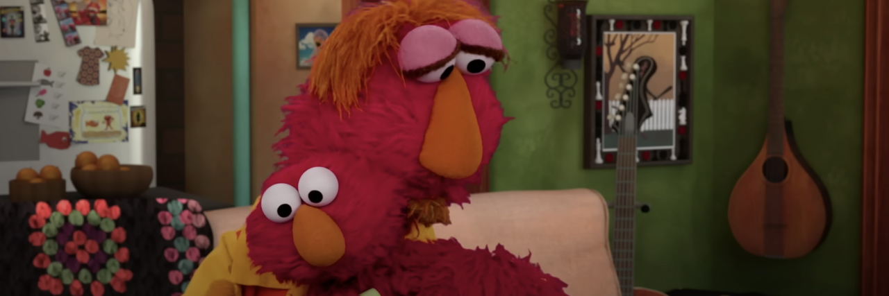 Elmo hugging his dad in their home