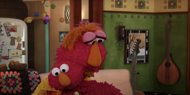 Elmo hugging his dad in their home