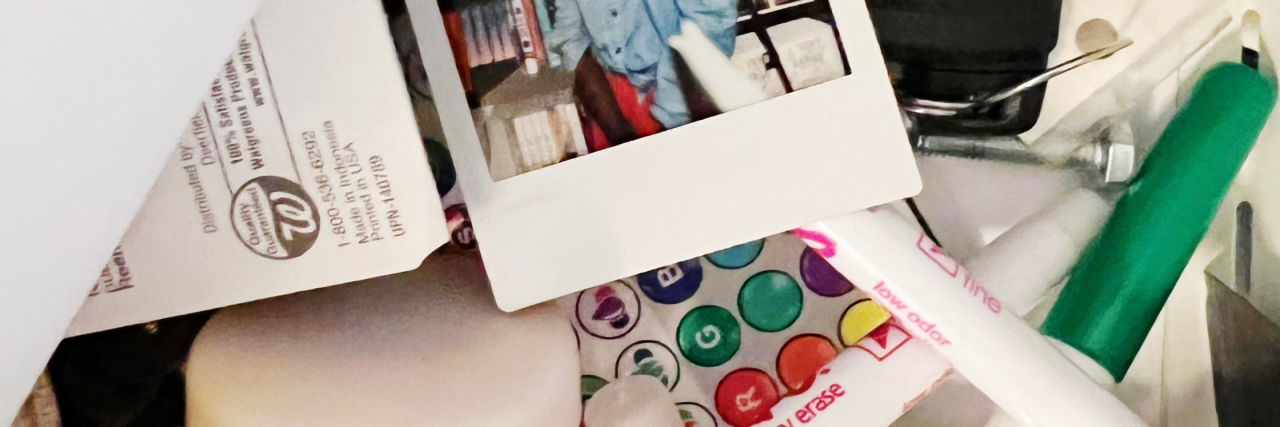 What Is an ADHD Clutter Box? And How to Effectively Use Them An assortment of polaroids, car keys, camera remotes, markers, covid vaccination cards, and papers in a drawer.