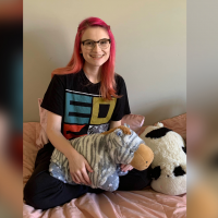 Skye Gailing the best and coolest person ever sits in an EDS shirt with a zebra stuffed animal