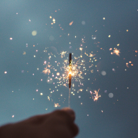 Photo of a hand holding a sparkler
