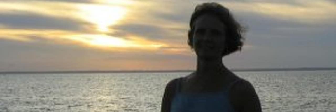 Regressing With Ehlers-Danlos Syndrome Subluxations The author stands in front of the ocean.