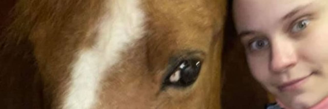 Balancing Work and School With Life With a Chronic Illness The author, a white woman wearing a patterned shirt, and her horse.