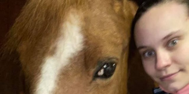 How I Balance Work, School, and Life With Chronic Illness The author, a white woman wearing a patterned shirt, and her horse.