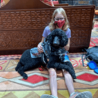 Kenzie with her service dog, a poodle named Atlas.