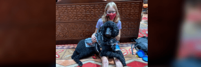 Kenzie with her service dog, a poodle named Atlas.