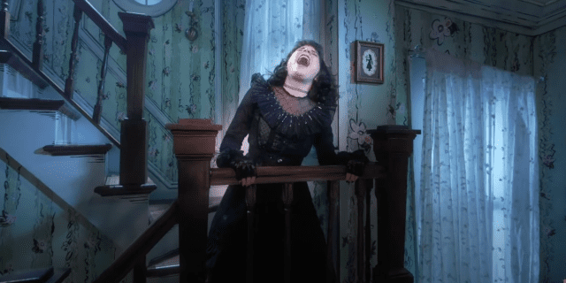 Lydia Deetz in "Beetlejuice The Musical" belting in the stairway of her house