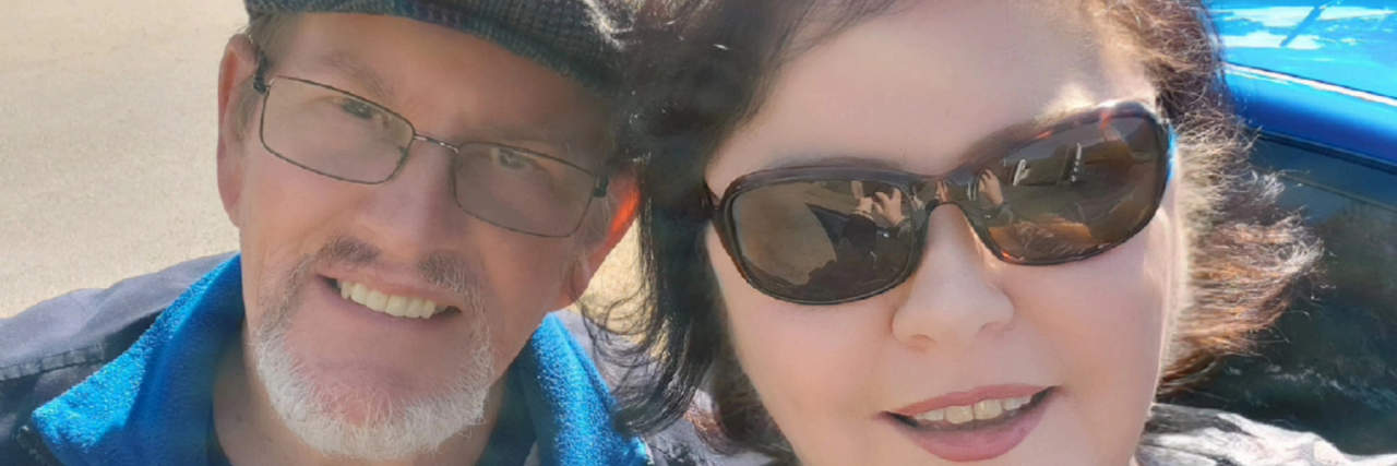 How to Seize the Day in Life With Chronic Illness Contributor and her husband celebrating her birthday with a view of the scenery behind them