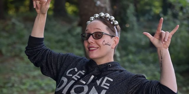 We Need to Talk About the Intersection of Femininity and Trauma Monika wearing a Celine Dion shirt