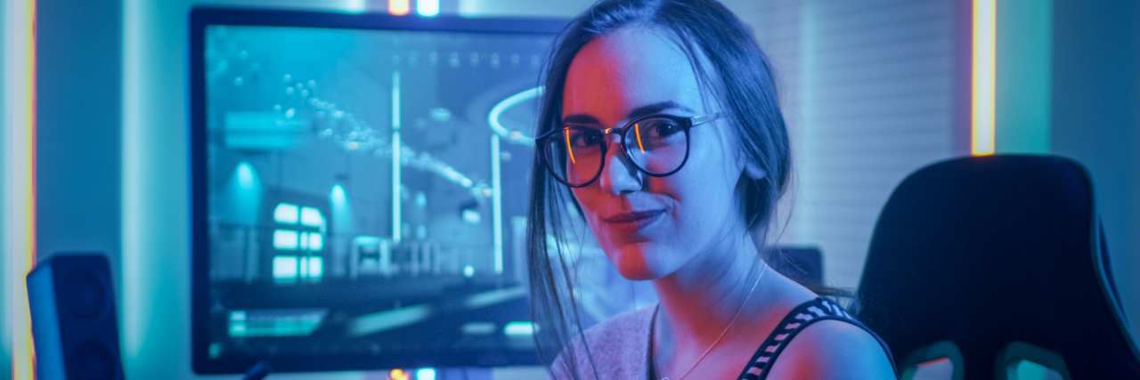4 Tips for Talking to Autistic People About Their Special Interests Young woman playing video games.