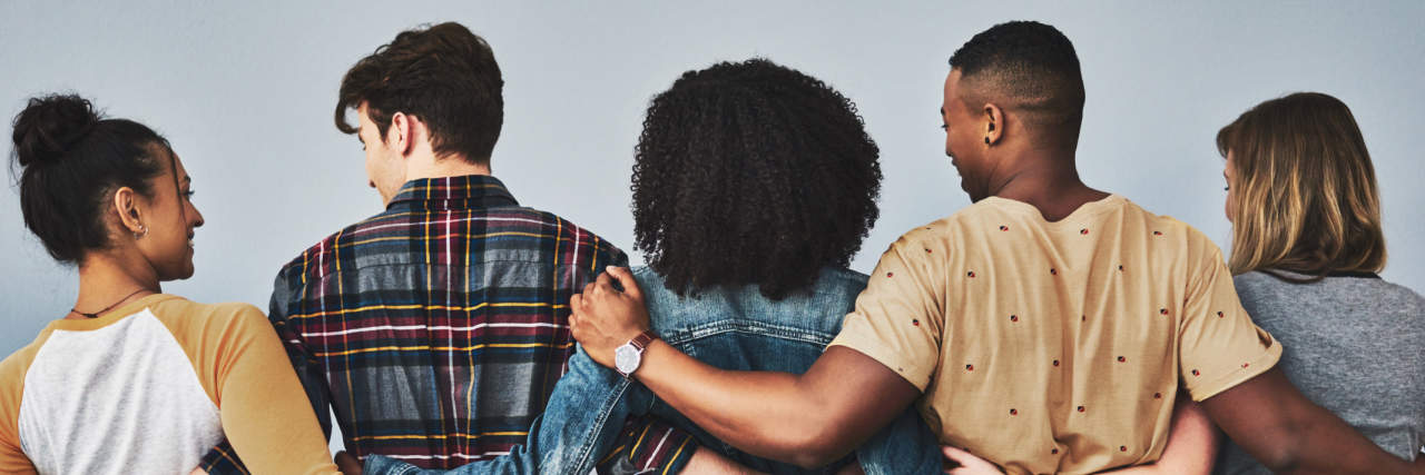 Advice for People Who Just Received a Chronic Illness Diagnosis Rearview studio shot of a diverse group of young people embracing each other against a gray background